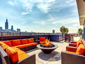 Community The Madison at Racine Rooftop Fire Pit, Resident rooftop lounge with a fire pit and skyline views of the Chicago at The Madison at Racine West Loop, Chicago, IL, 60607 - Photo Gallery 5