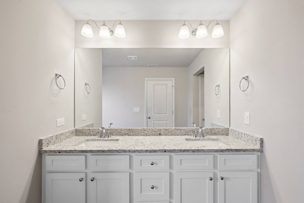a bathroom with two sinks and a large mirror