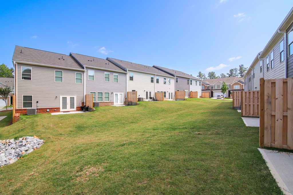 a row of houses on a grassy lot