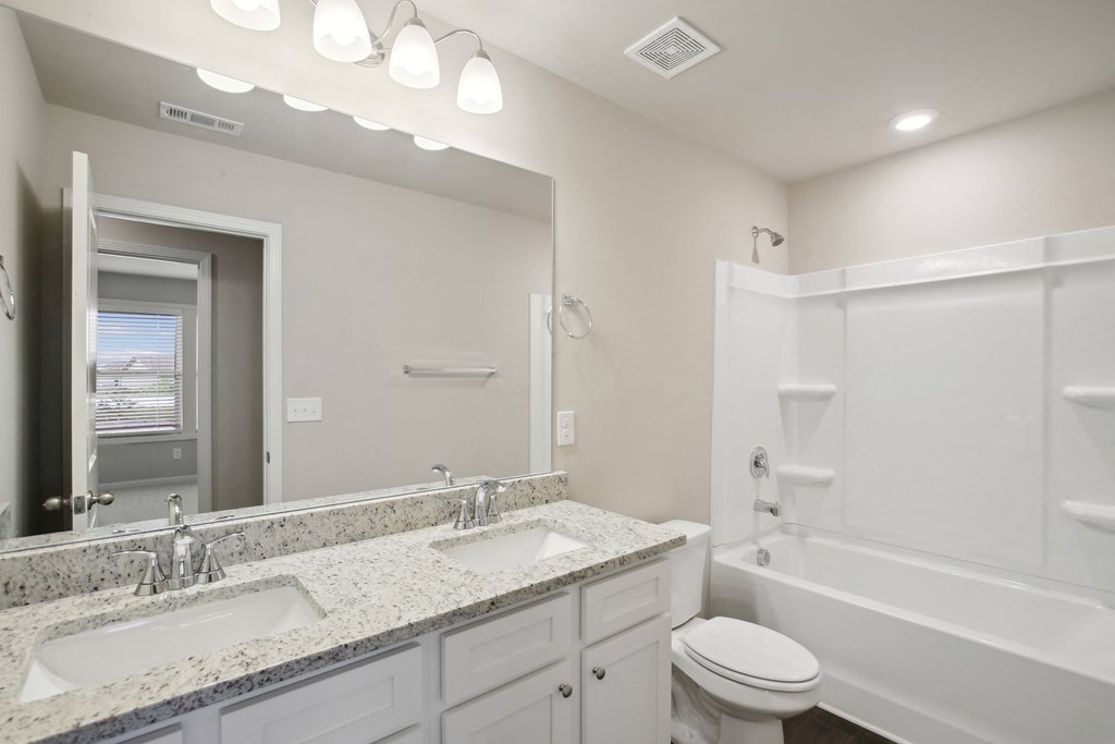 a bathroom with a large mirror and two sinks