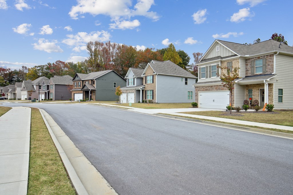 an empty street with houses on the side of it