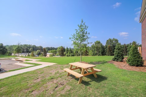 Enjoy the outdoors with charming community spaces featuring picnic seating.