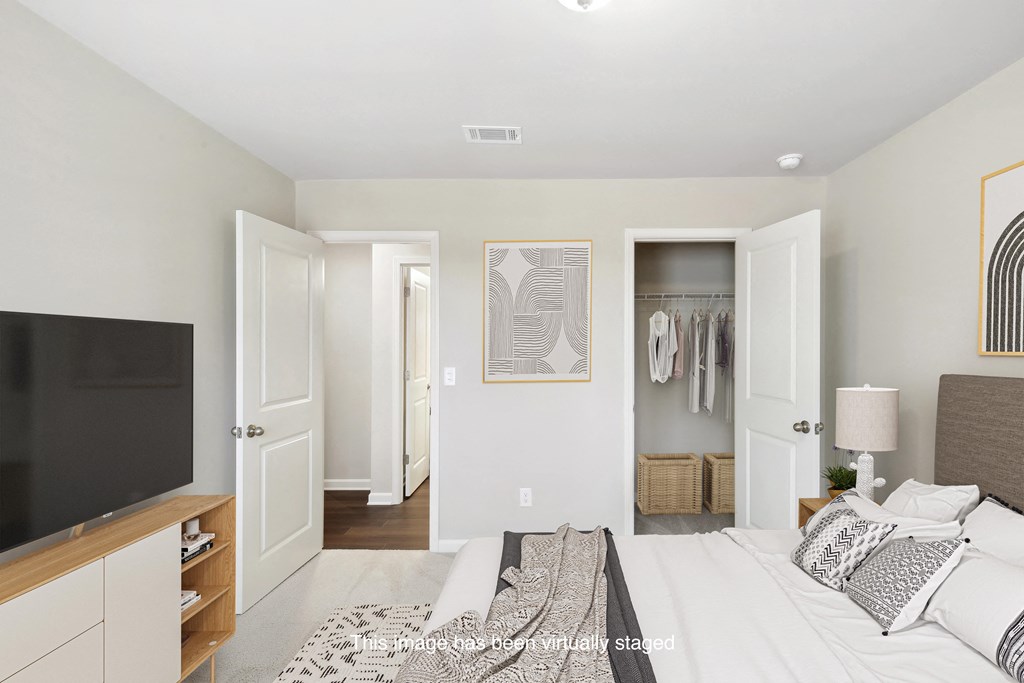 a bedroom with a bed and a tv and a closet