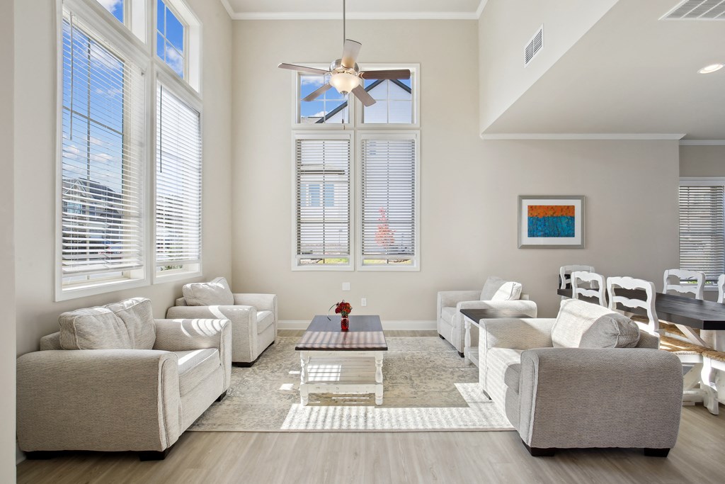 a living room with couches and chairs and a table
