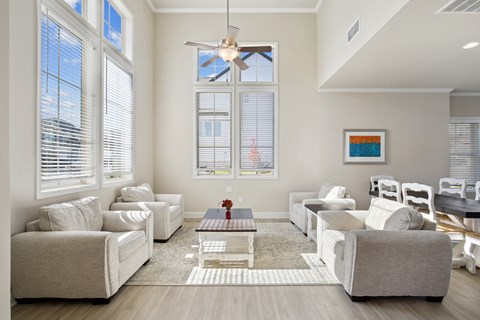 a living room with couches and chairs and a table