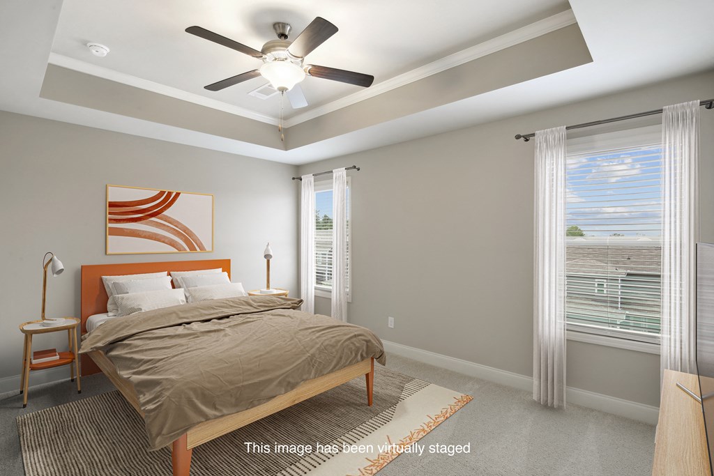 a bedroom with a bed and a ceiling fan