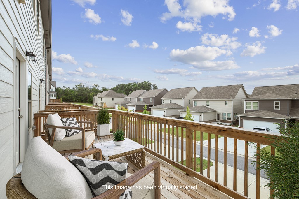 a patio with a chair and a table on a balcony