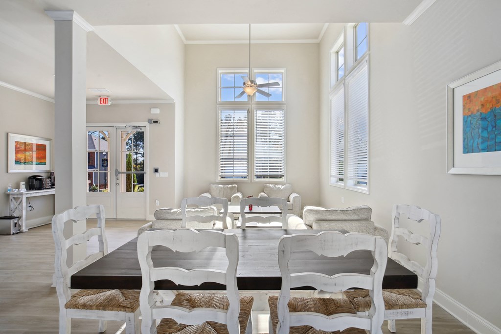 a dining room with a table and chairs and a window