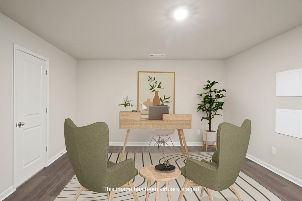 an image of a living room with two chairs and a table