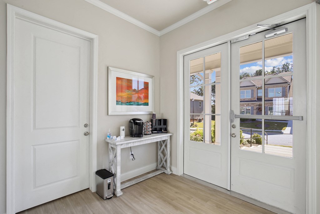 a room with two doors and a table in the corner