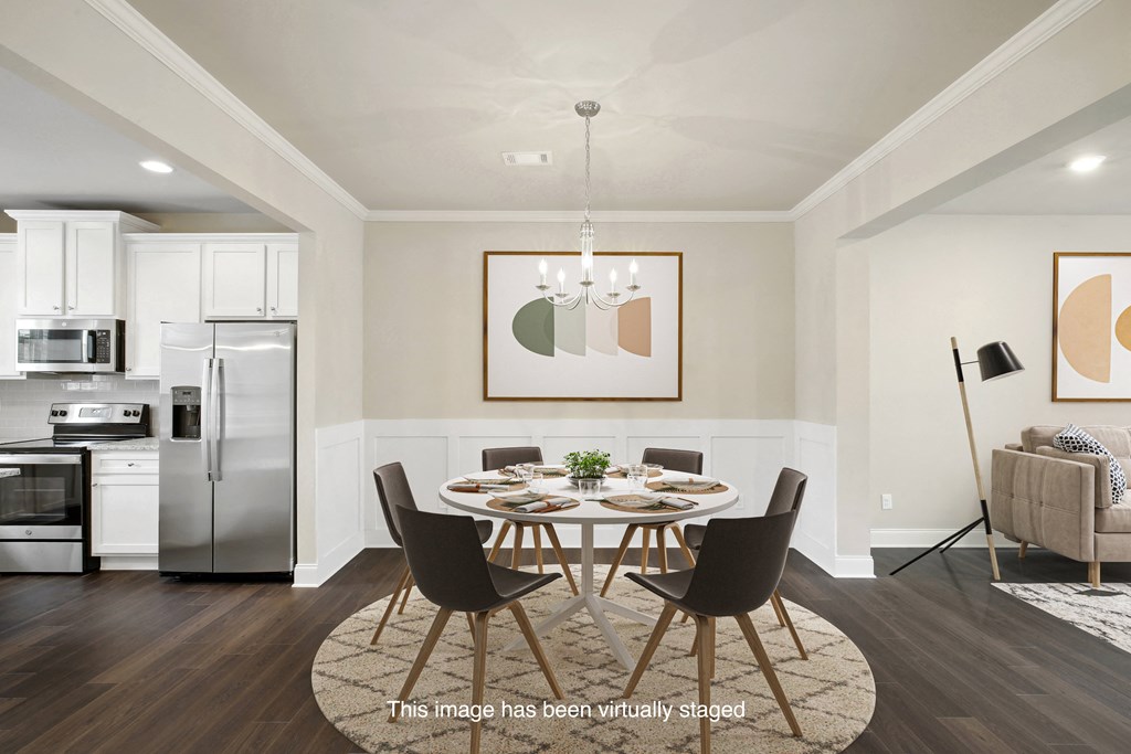 an image of a dining room with a table and chairs