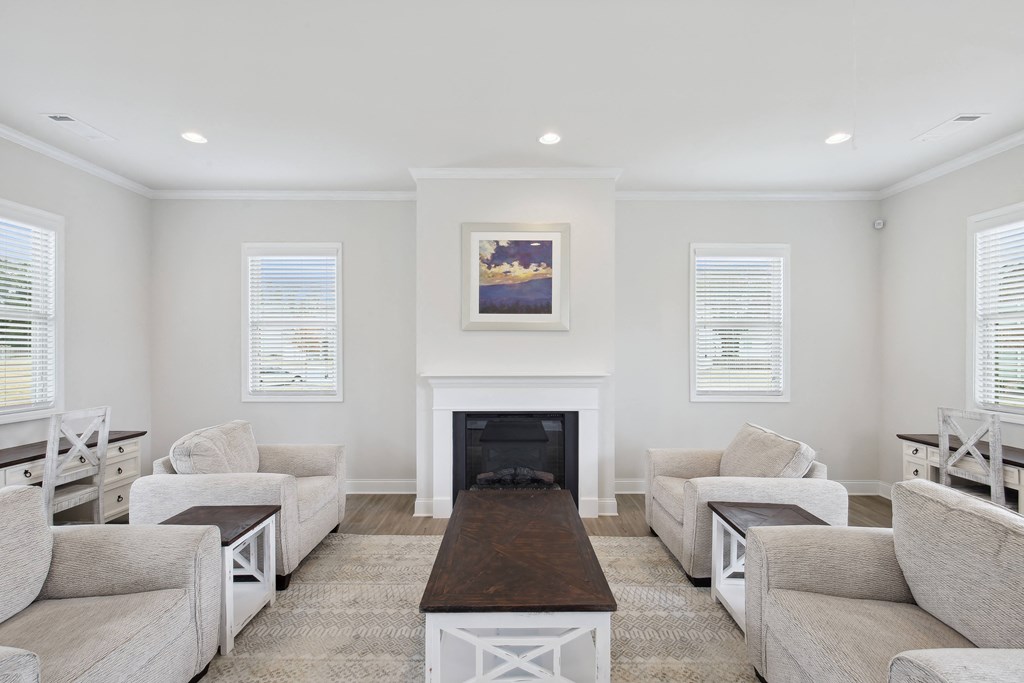 a living room with couches and a table and a fireplace