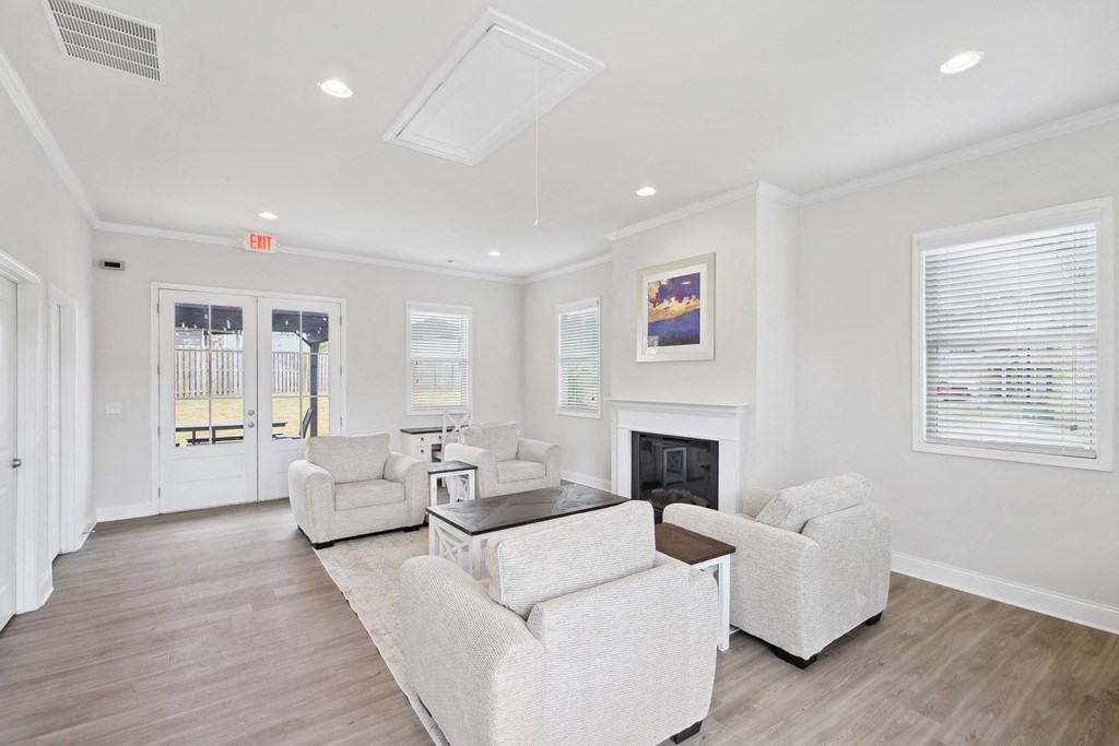 a living room with couches and chairs and a fireplace