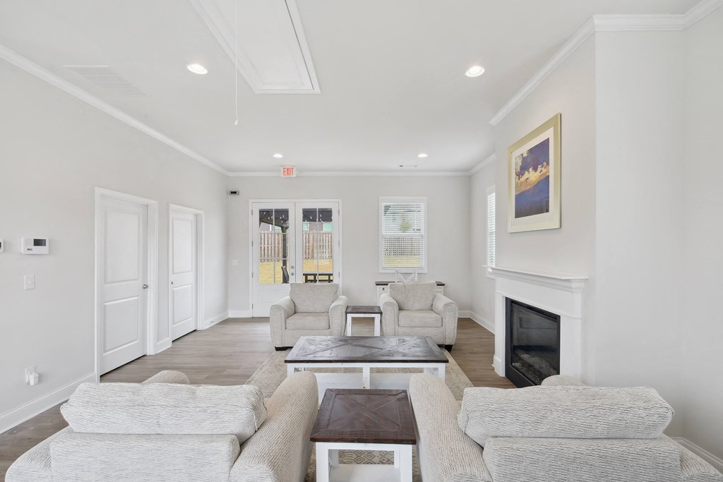 a living room with white furniture and a fireplace