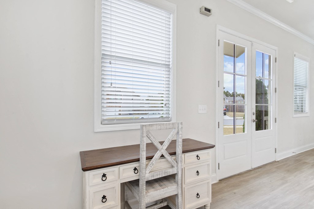 a room with a desk and a chair next to a door