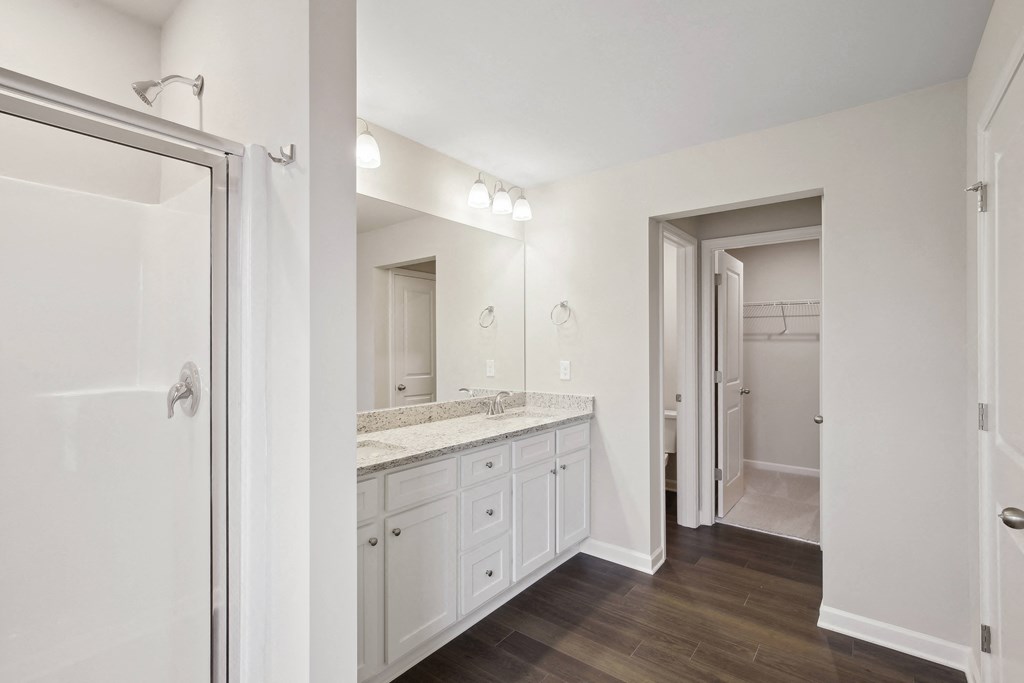 a bedroom with a medium sized bed and a mirror