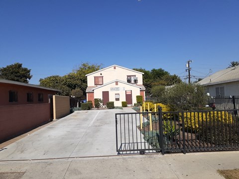 A house with a black gate in front of it.