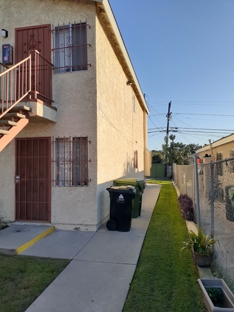 A building with a red door and a balcony.