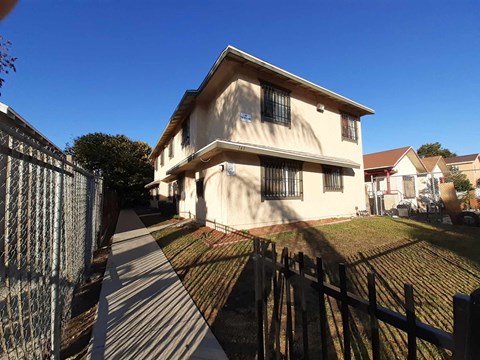 A house with a fence in front of it.