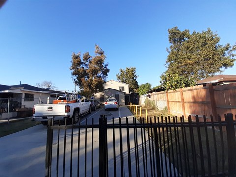 A white truck is parked on a driveway.