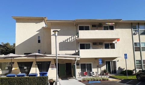 the exterior of a building with umbrellas in front of it