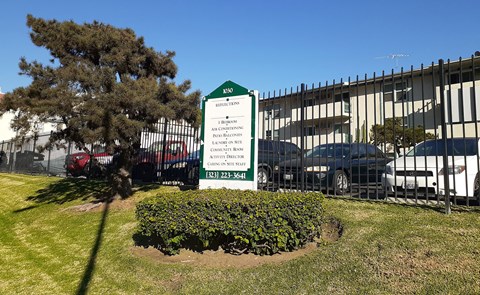 a sign for a bus stop in front of a building