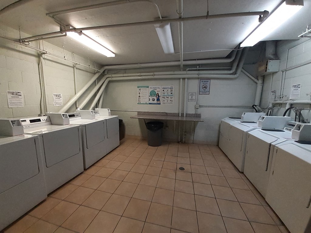 the laundry room is full of washers and dryers