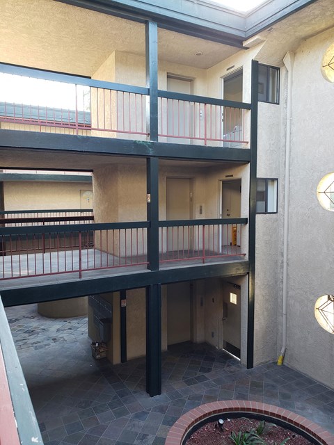 a view of a building with a balcony and a fire pit