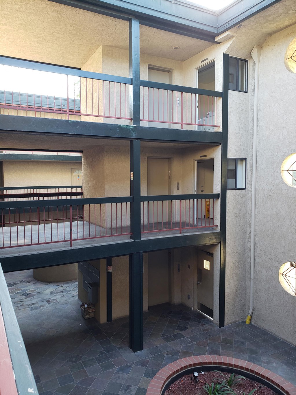a view of a building with a balcony and a fire pit