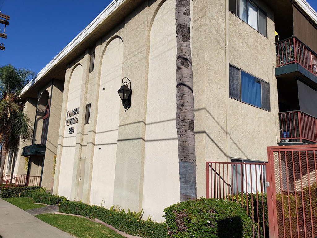 the side of a building with a tree in front of it