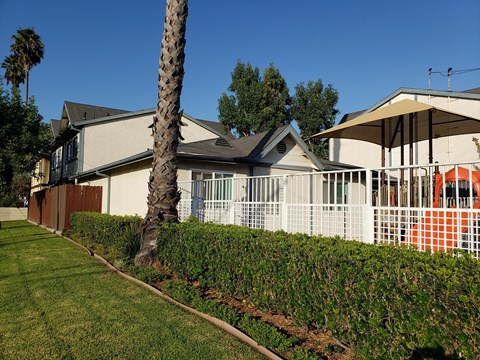 A house with a palm tree in front of it.