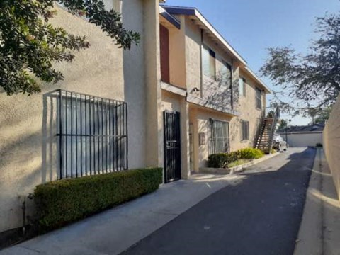 A row of houses with black iron gates.