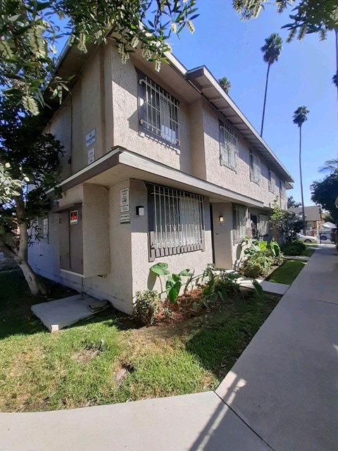 A two-story house with a balcony on the second floor.