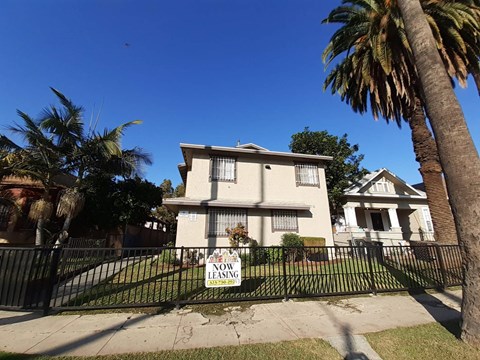 A house with a "Now Leasing" sign in front of it.