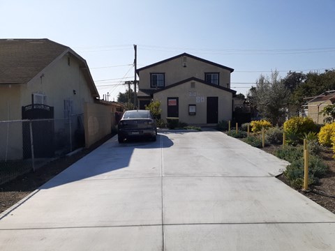 A car is parked on a driveway in front of a house.