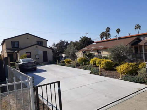 A car is parked on a driveway in front of a house.