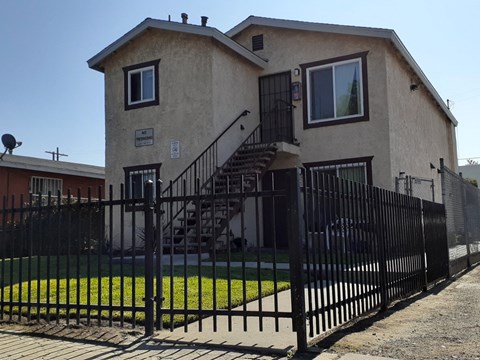 A house with a black fence in front of it.