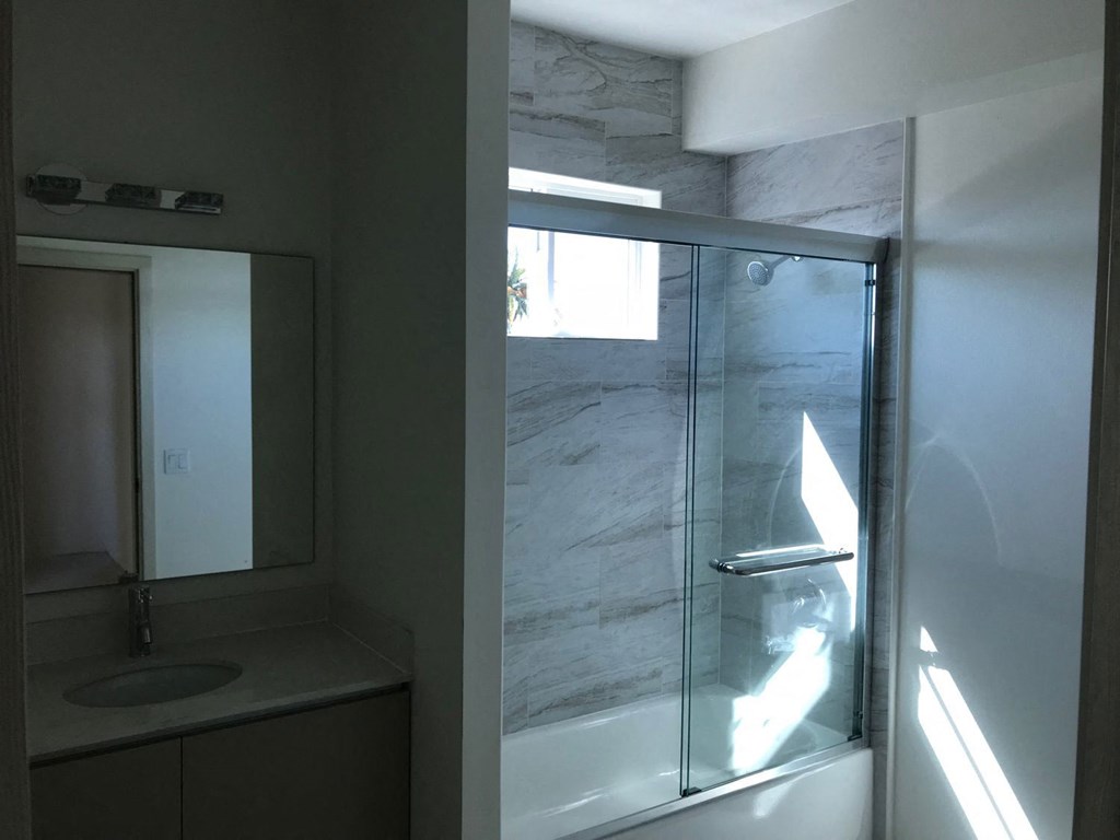 a small bathroom with a shower and a sink