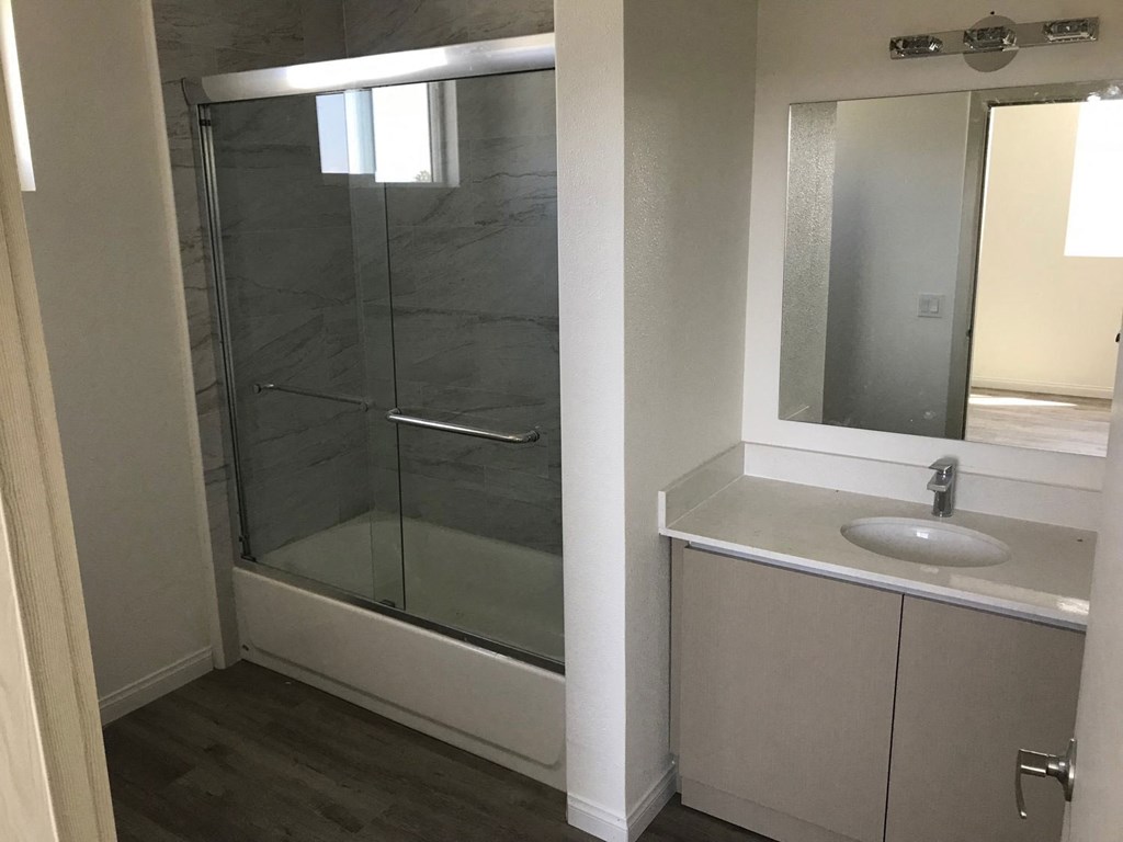 a small bathroom with a shower and a sink