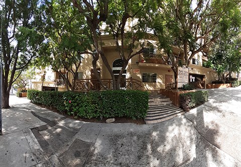 a building with stairs and trees in front of it