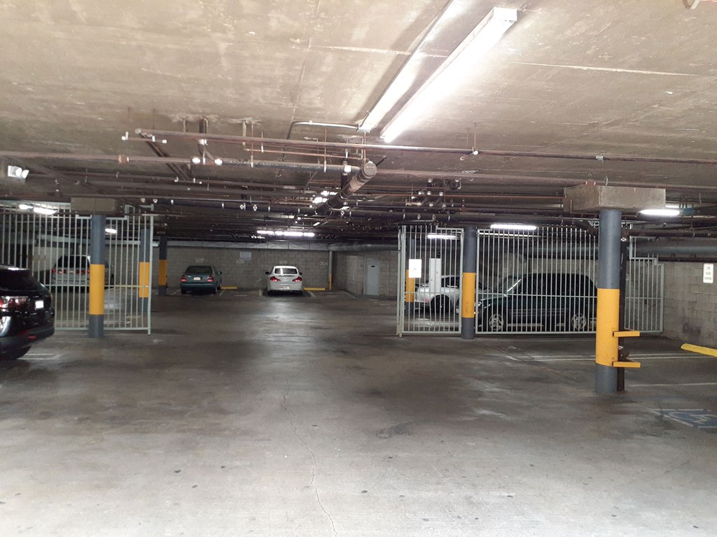 the inside of a parking garage with cars in it