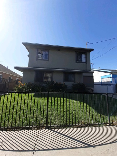 A house with a black fence in front of it.