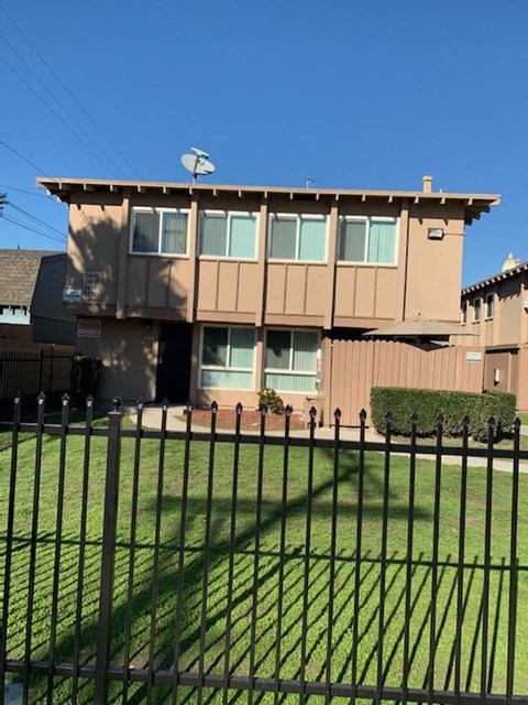 A house with a black fence in front of it.