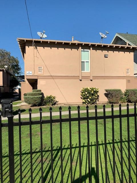 A house with a black fence in front of it.