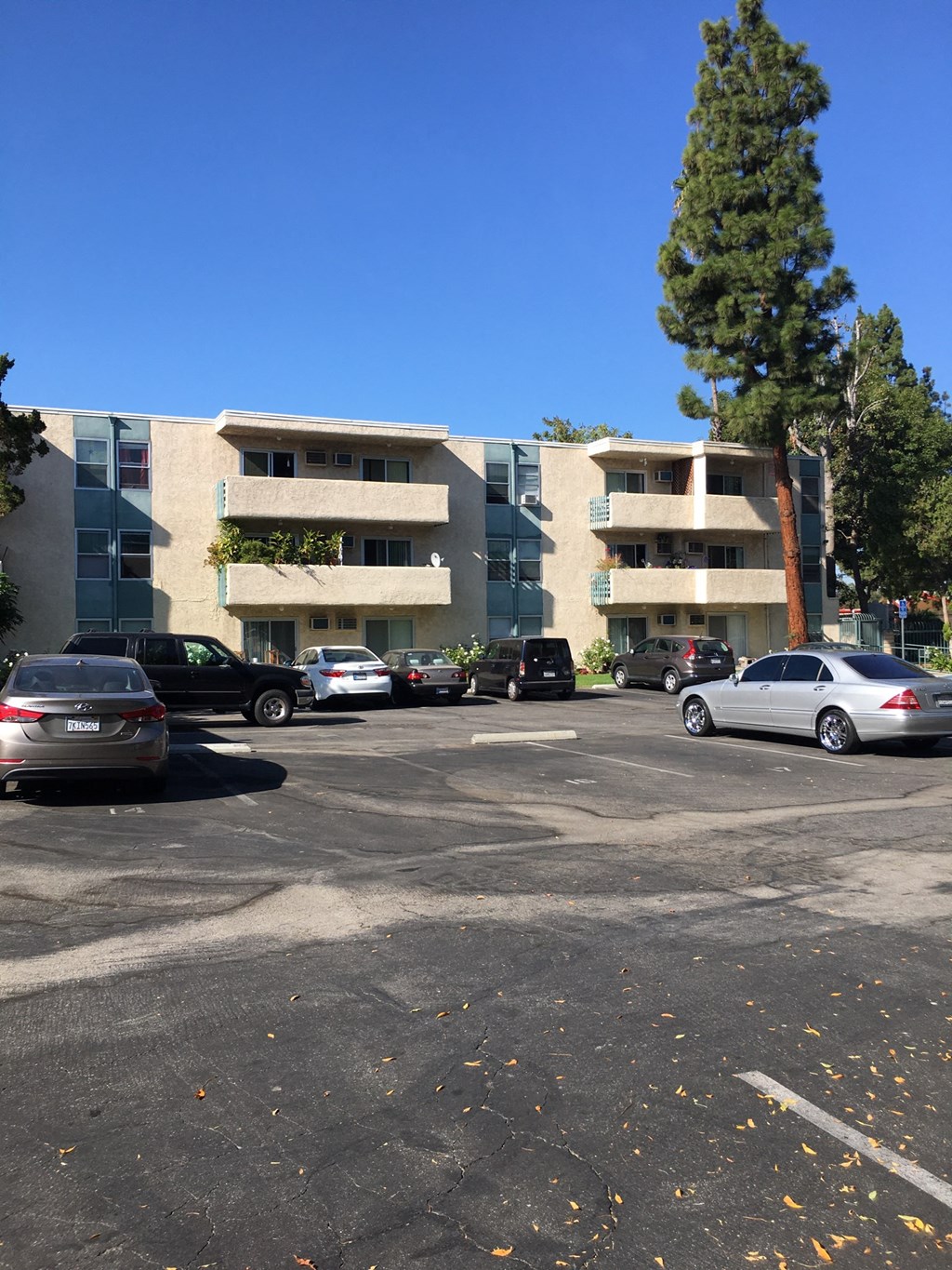 an empty parking lot in front of an apartment building