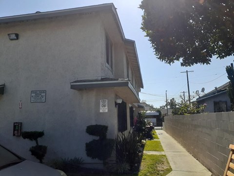 A house with a sign on the wall that says "No Parking".
