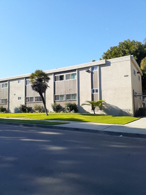 a building with palm trees in front of it