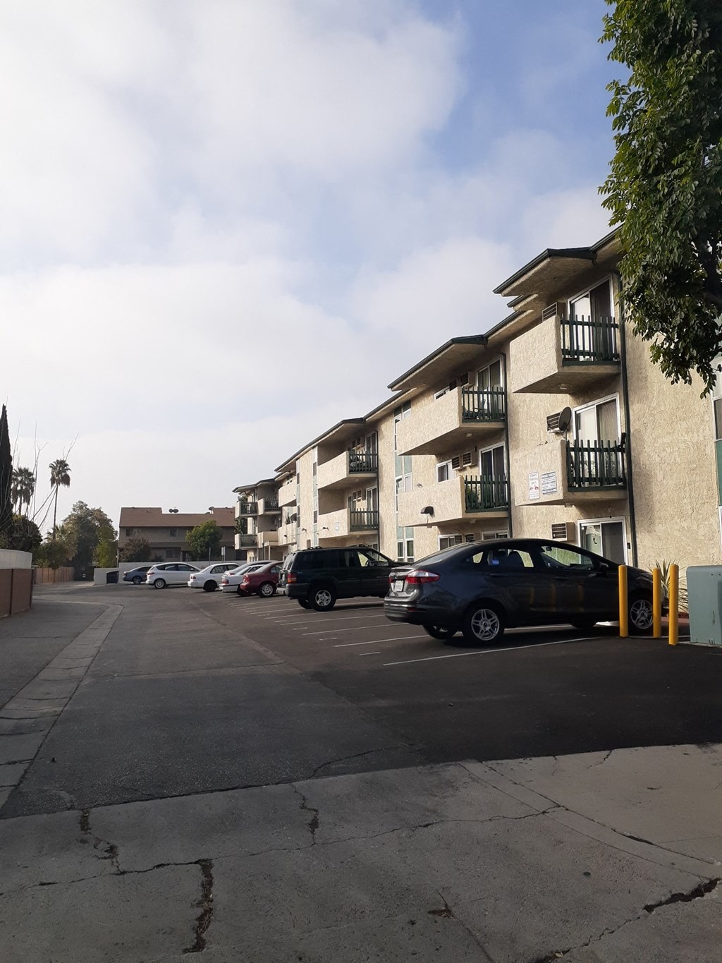 a parking lot in front of an apartment building
