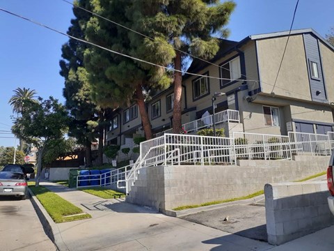 A residential building with a tree in front of it.