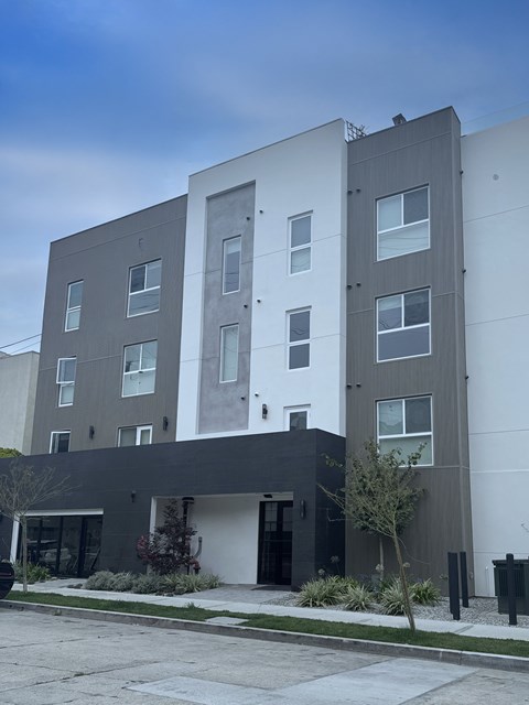 A modern building with a mix of grey and white exterior.